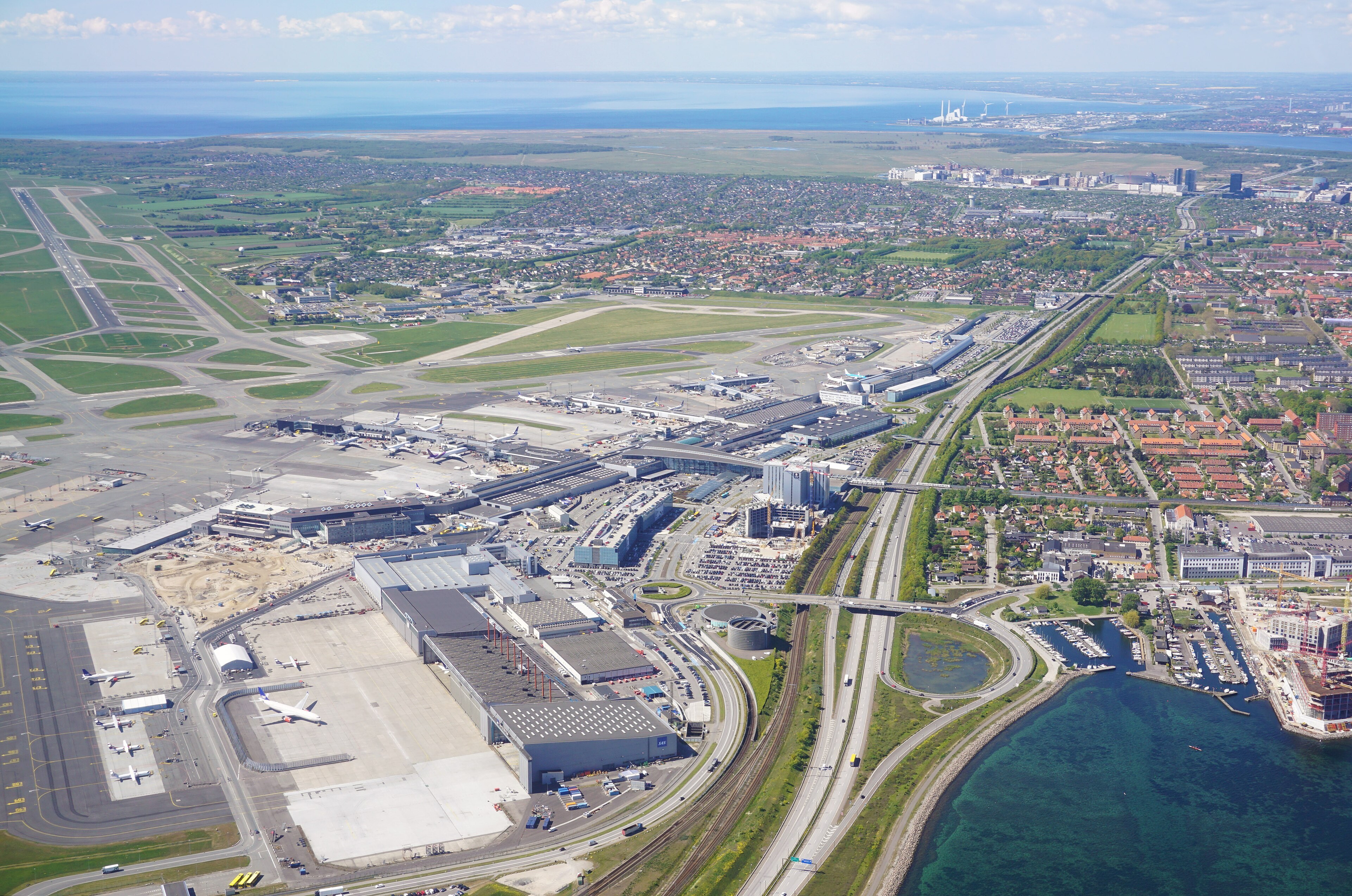 Copenhagen Airport at Kastrup seen from the air, terminal and aprons beside the Sound