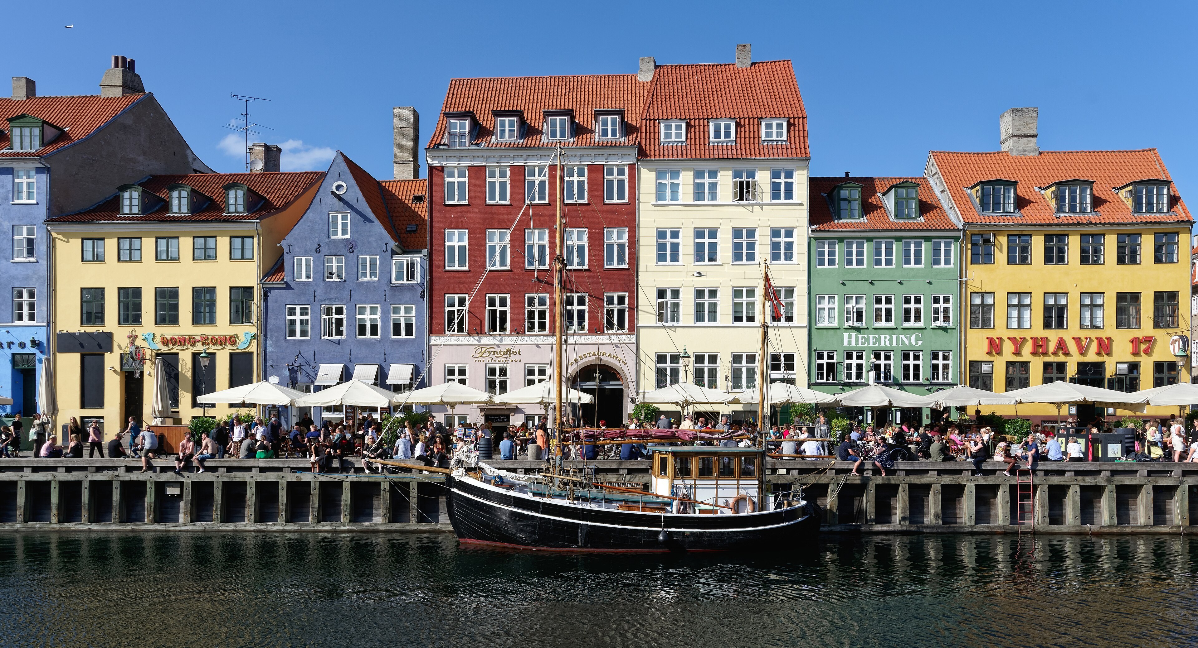 Nyhavn in Copenhagen, the canal lined with colour-washed town houses and moored boats